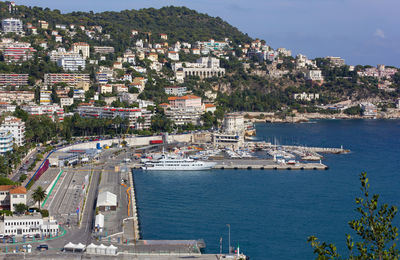 High angle view of townscape by sea against buildings