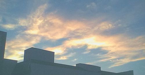 Low angle view of building against sky at sunset