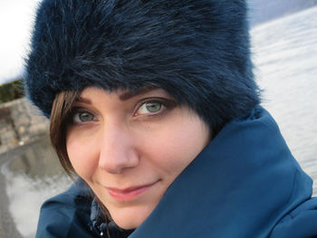 Close-up portrait of woman wearing fur hat during winter