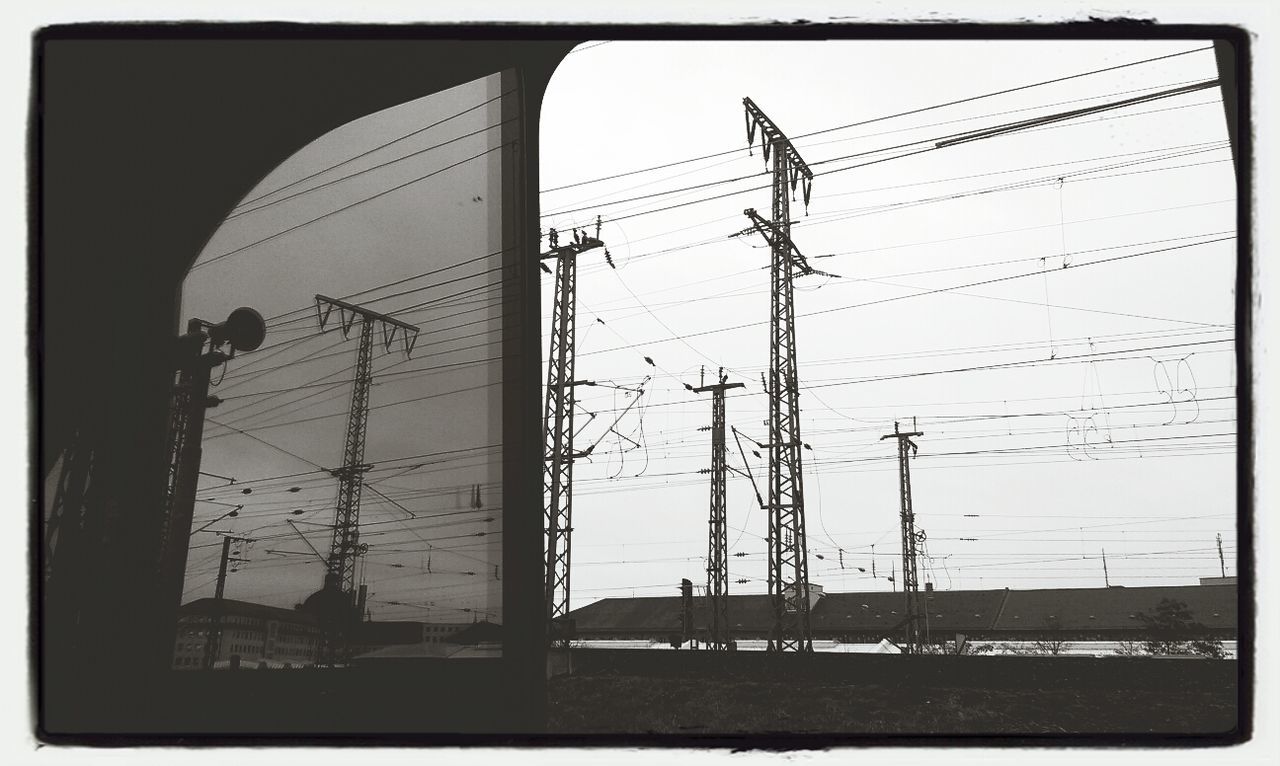 power line, electricity pylon, power supply, electricity, fuel and power generation, transfer print, connection, cable, technology, sky, auto post production filter, low angle view, built structure, power cable, architecture, day, no people, outdoors, building exterior, complexity