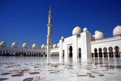 View of mosque against clear blue sky