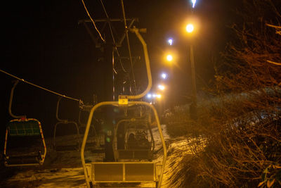 Light trails on street against sky at night