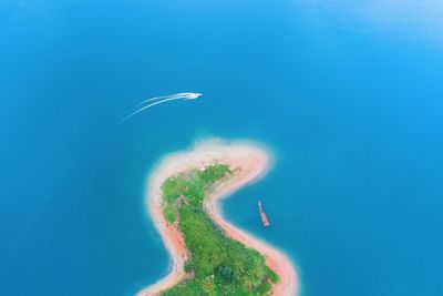 Aerial view of sea against clear blue sky