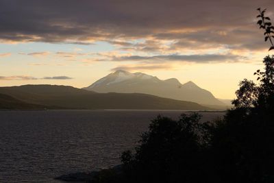 Scenic view of mountains against cloudy sky