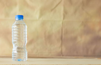 Close-up of glass bottle on table