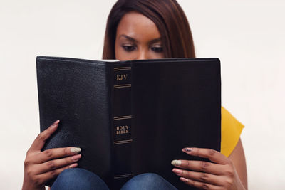 Cropped image of woman holding book