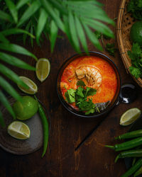 High angle view of thai tom yum soup in bowl on table