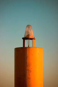 Low angle view of lamp against orange sky