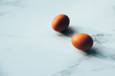 Close-up of orange apple on table