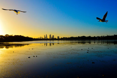 Lake monger reserve at sunset and perth skyline