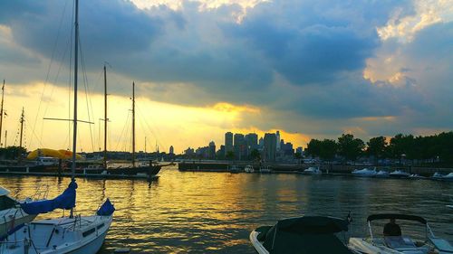 Boats in sea at sunset