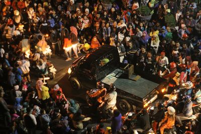 High angle view of protestors protesting on street in city at night