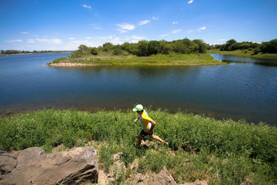 Man surfing in lake against sky