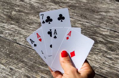 Low section of person playing with umbrella on table