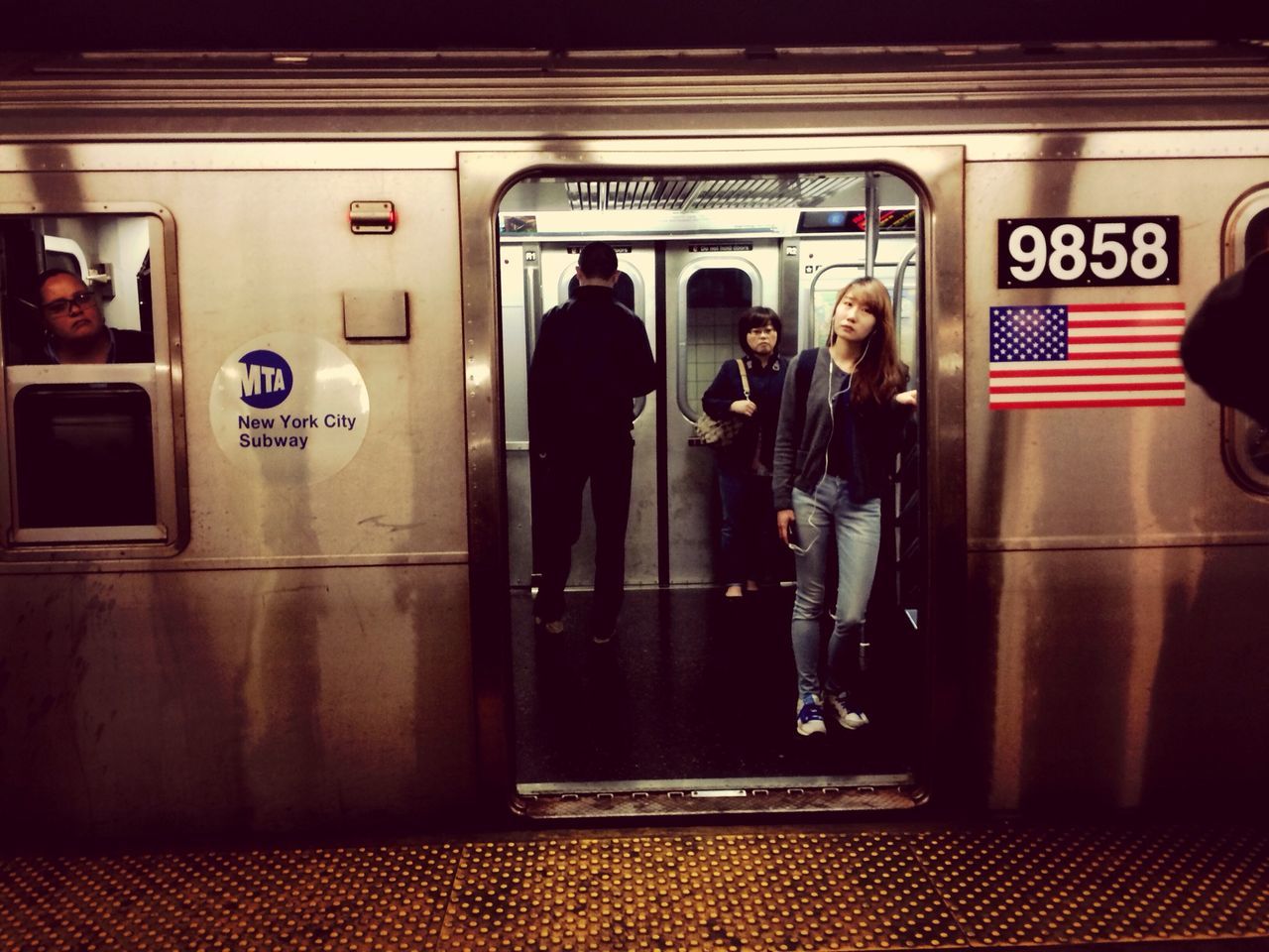 men, lifestyles, indoors, text, person, public transportation, communication, leisure activity, transportation, western script, rear view, standing, railroad station, walking, full length, travel, passenger, non-western script