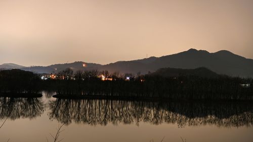 Scenic view of lake against sky during sunset