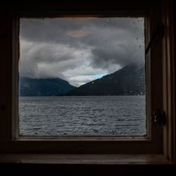 Scenic view of sea seen through glass window