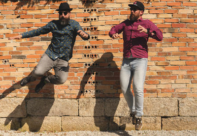 Men with beards jump
