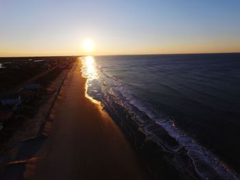 Scenic view of sea against clear sky during sunset