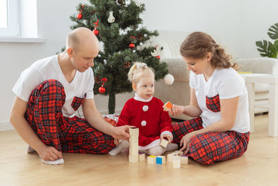 Family sitting on sofa at home