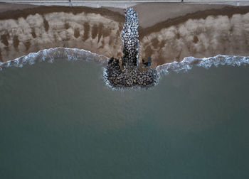 Looking down on waves breaking on a beach in suffolk, uk