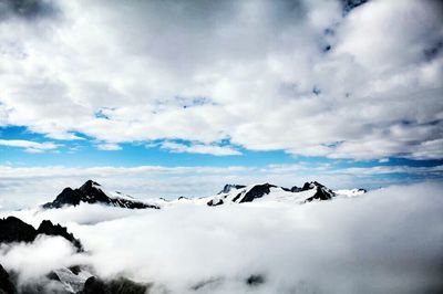 Scenic view of mountains against cloudy sky