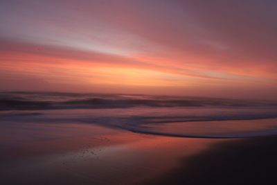 Scenic view of sea against sky during sunrise 