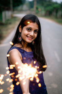 Portrait of smiling young woman standing outdoors