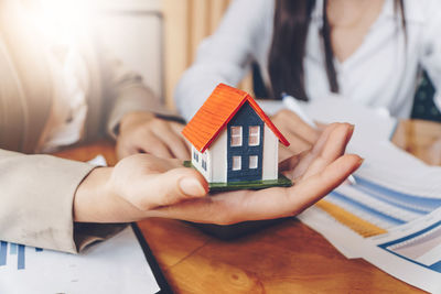 High angle view of woman holding hands outside house