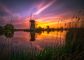 Scenic view of lake against sky at sunset