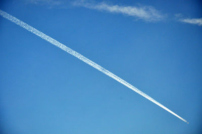 Aerial view of vapor trail against blue sky