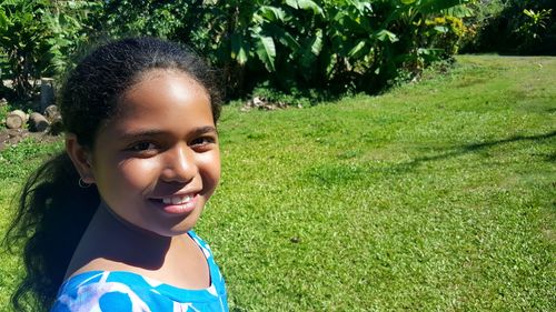 Close-up portrait of smiling girl at park