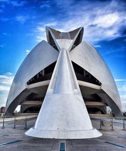 Low angle view of modern building against cloudy sky