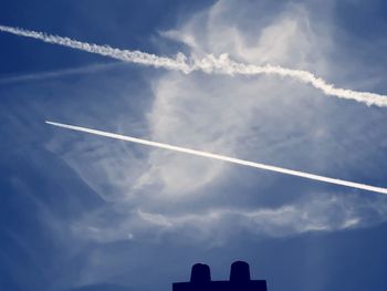 Low angle view of vapor trails in sky