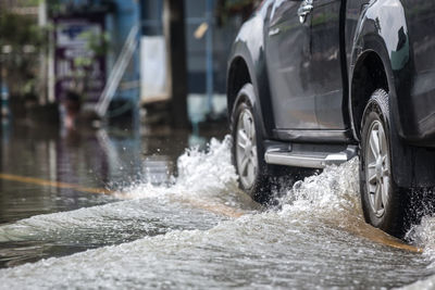 Pick-up truck on a flooded street.