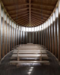 Wooden benches below roof beam in church