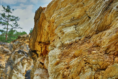 Low angle view of rock formation against sky