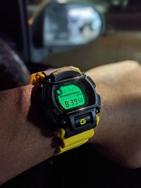 Close-up of person hand on clock