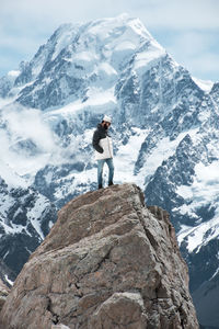 Man standing on top of mountain