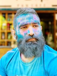 Close-up portrait of bearded man covered in powder paint