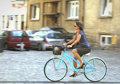 Side view of woman walking on city street