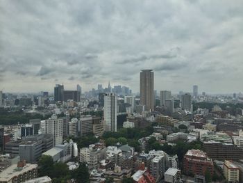 Cityscape against cloudy sky