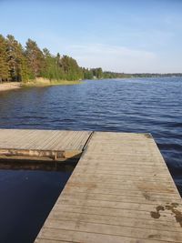 Pier over lake against sky