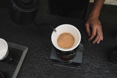 Midsection of coffee cup on table