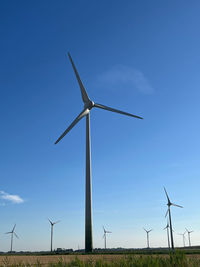 Low angle view of windmill against sky