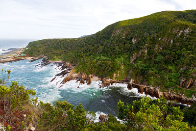 Scenic view of sea and mountains against sky