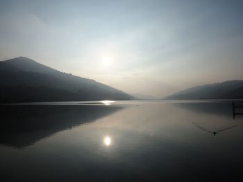 Scenic view of lake against sky during sunset