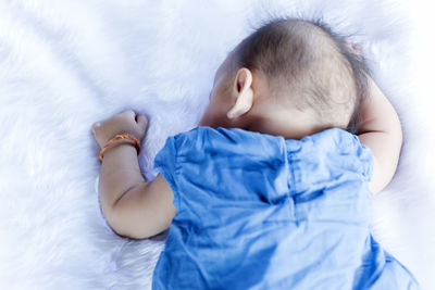 Newborn baby boy portrait on white carpet closeup. motherhood and new life concept