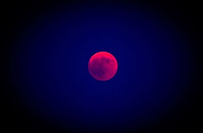 Low angle view of moon against blue sky