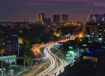 Light trails on road in city at night